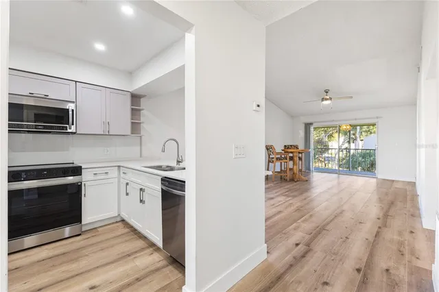 a kitchen with granite countertop a stove top oven and sink