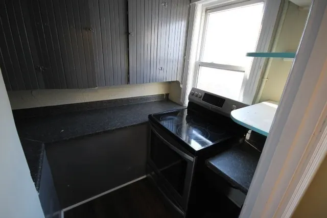 a living room with a chair and a window