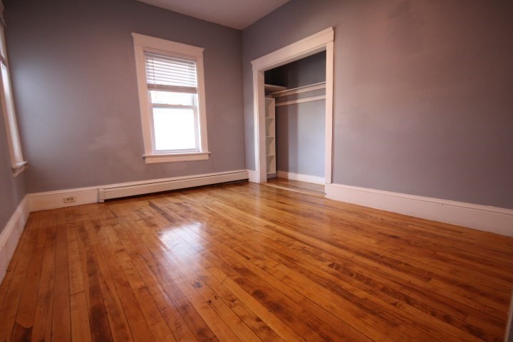 82 Green Hill Parkway Worcester, MA 01605 - Photo 19 of 42 an empty room with wooden floor and windows