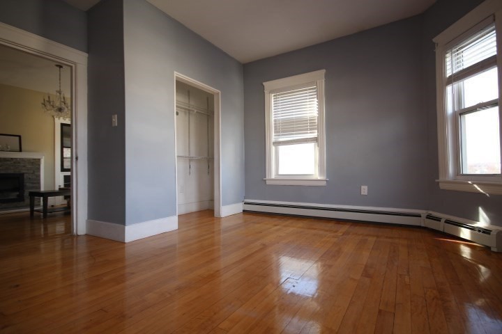 82 Green Hill Parkway Worcester, MA 01605 - Photo 23 of 42 an empty room with wooden floor and windows