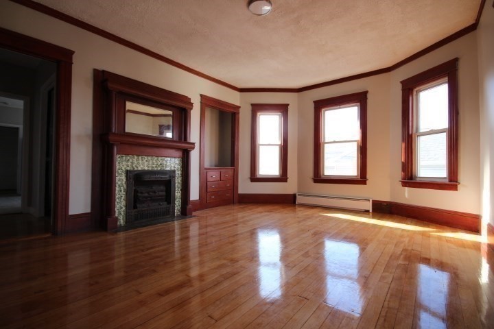 82 Green Hill Parkway Worcester, MA 01605 - Photo 24 of 42 a view of empty room with wooden floor and fireplace