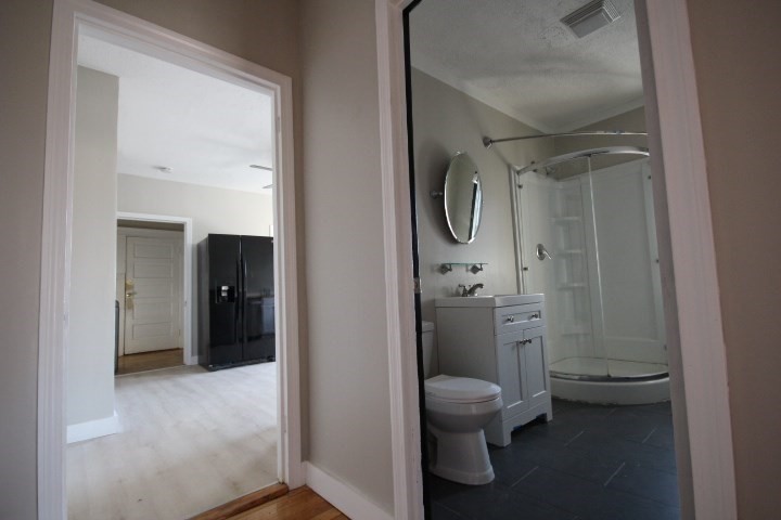 82 Green Hill Parkway Worcester, MA 01605 - Photo 26 of 42 a bathroom with a granite countertop toilet a sink and a mirror
