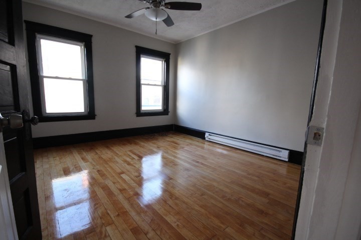 82 Green Hill Parkway Worcester, MA 01605 - Photo 28 of 42 an empty room with wooden floor and windows