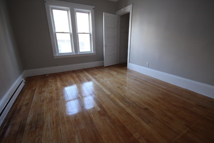 82 Green Hill Parkway Worcester, MA 01605 - Photo 34 of 42 an empty room with wooden floor and windows