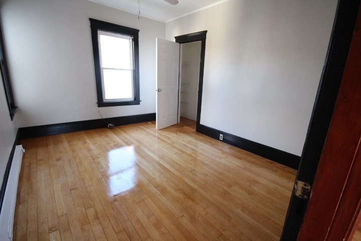 82 Green Hill Parkway Worcester, MA 01605 - Photo 35 of 42 an empty room with wooden floor and windows