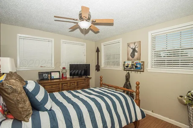 a bedroom with bed and a window