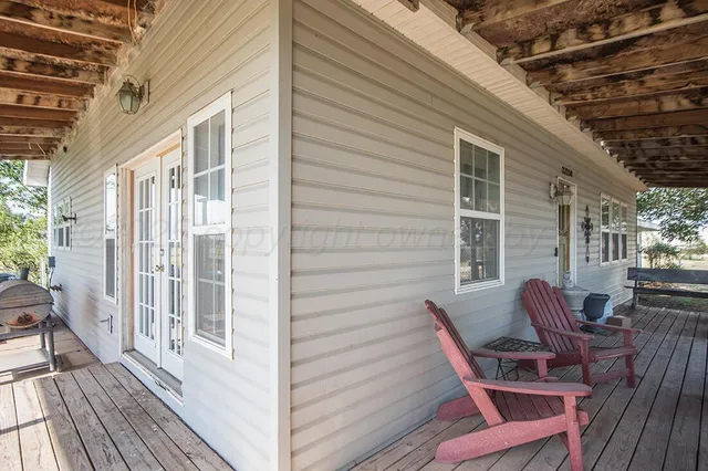 a view of a patio with a table and chairs