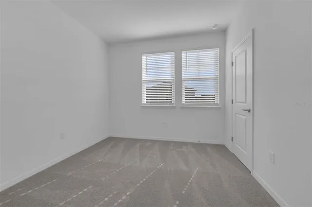 a dining table with chairs and window