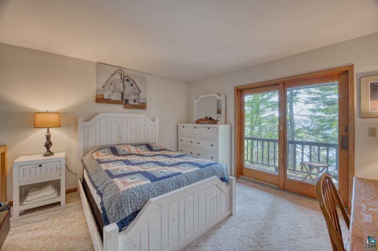 6312 Juniper Lane Gilbert, MN 55741 - Photo 19 of 50 Bedroom with access to exterior and light colored carpet