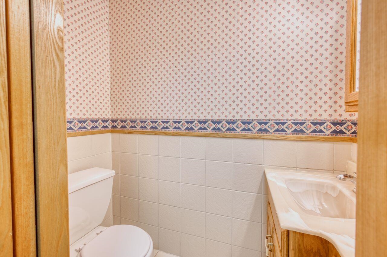 6312 Juniper Lane Gilbert, MN 55741 - Photo 24 of 50 Bathroom with vanity, toilet, and tile walls