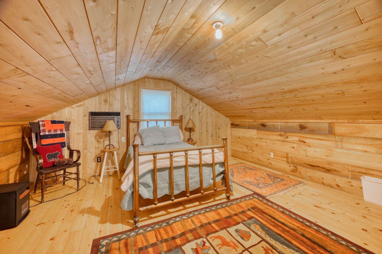 6312 Juniper Lane Gilbert, MN 55741 - Photo 32 of 50 Bedroom with vaulted ceiling, light wood-type flooring, wooden ceiling, and wooden walls