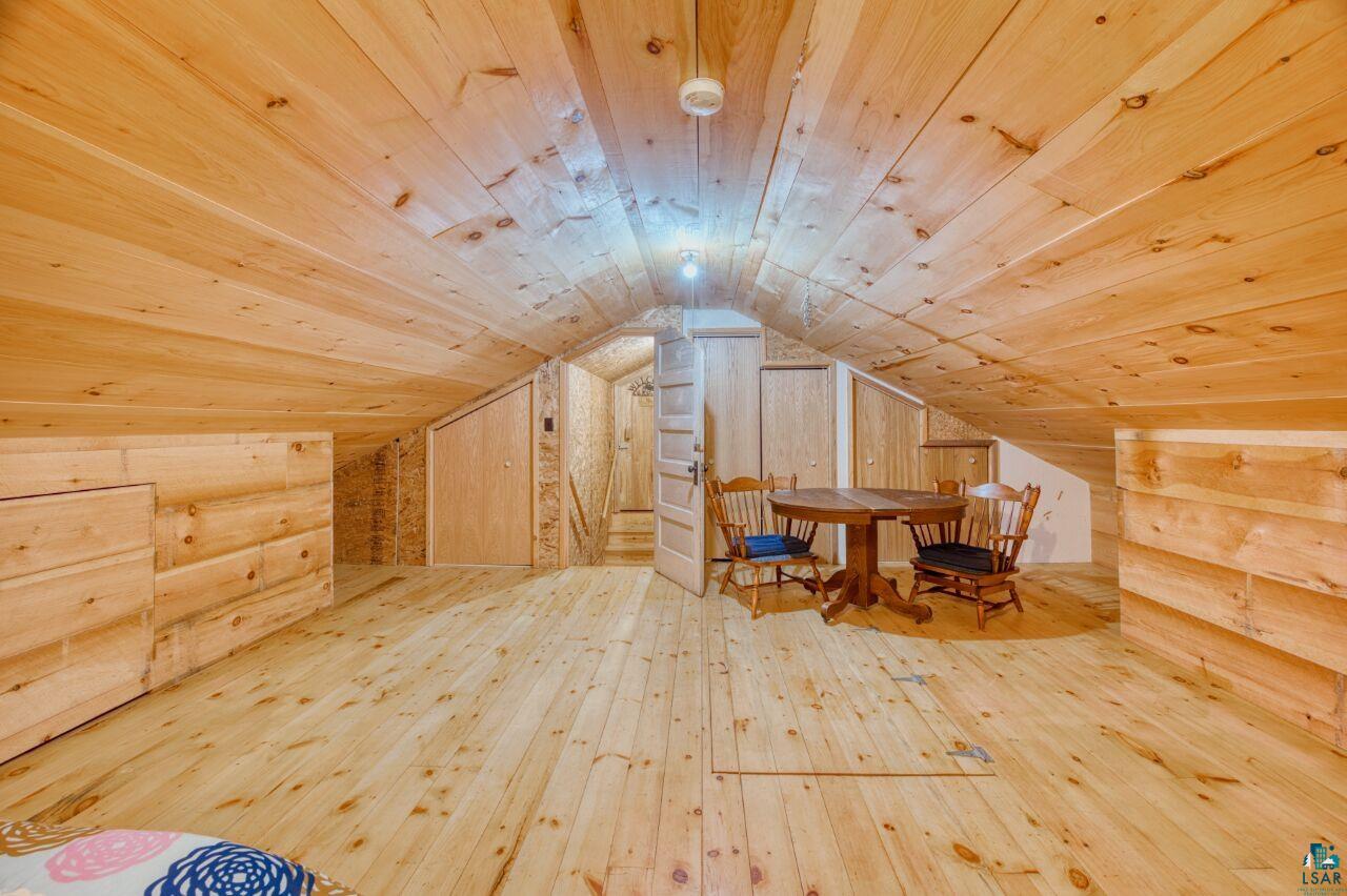 6312 Juniper Lane Gilbert, MN 55741 - Photo 34 of 50 Additional living space featuring lofted ceiling, wood walls, wood-type flooring, and wooden ceiling