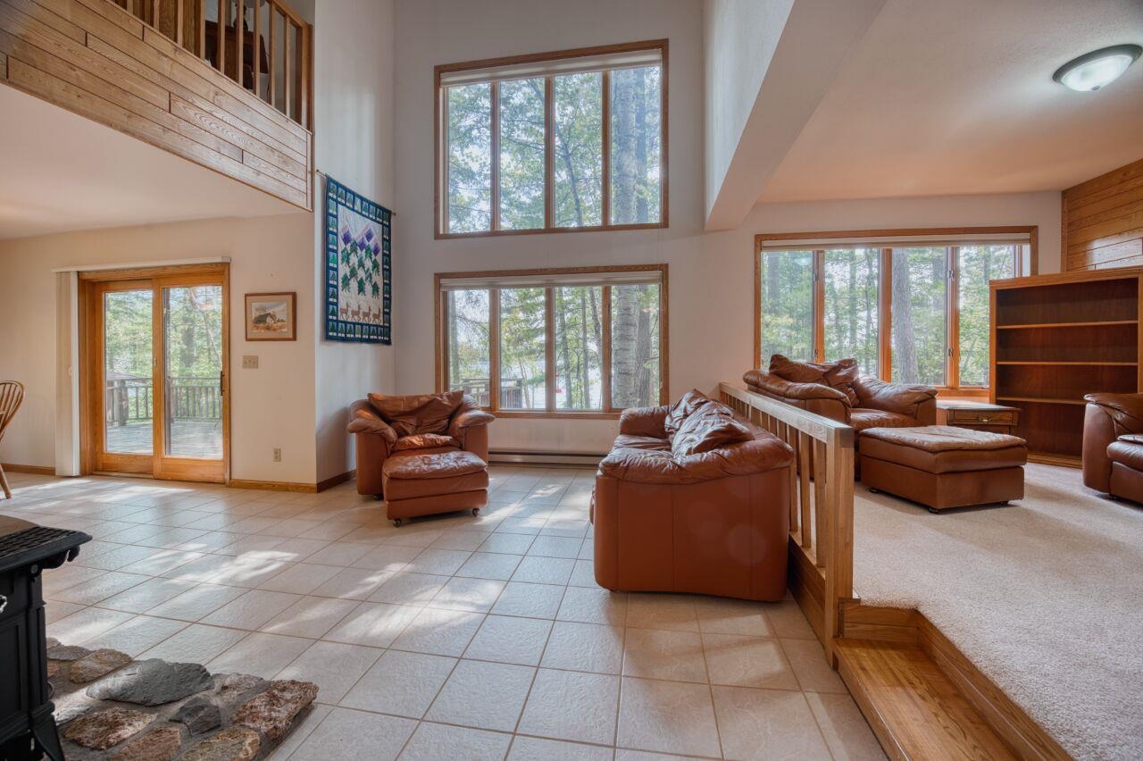 6312 Juniper Lane Gilbert, MN 55741 - Photo 4 of 50 Tiled living room with a wealth of natural light and a high ceiling