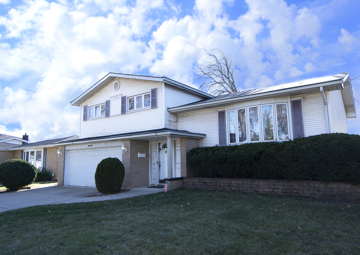 81 Ambleside Road Des Plaines, IL 60016 - Photo 2 of 24 a front view of a house with a garden