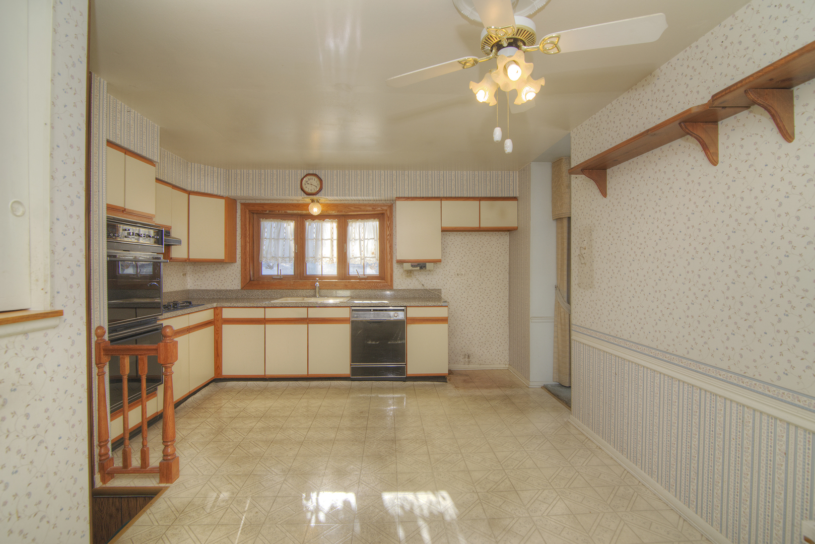 81 Ambleside Road Des Plaines, IL 60016 - Photo 12 of 24 a large kitchen with a large window and stainless steel appliances