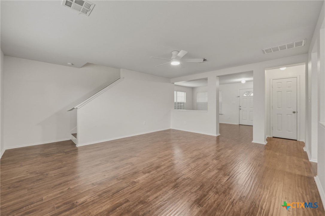 109 Comal Cove Elgin, TX 78621 - Photo 6 of 34 a view of an empty room with wooden floor