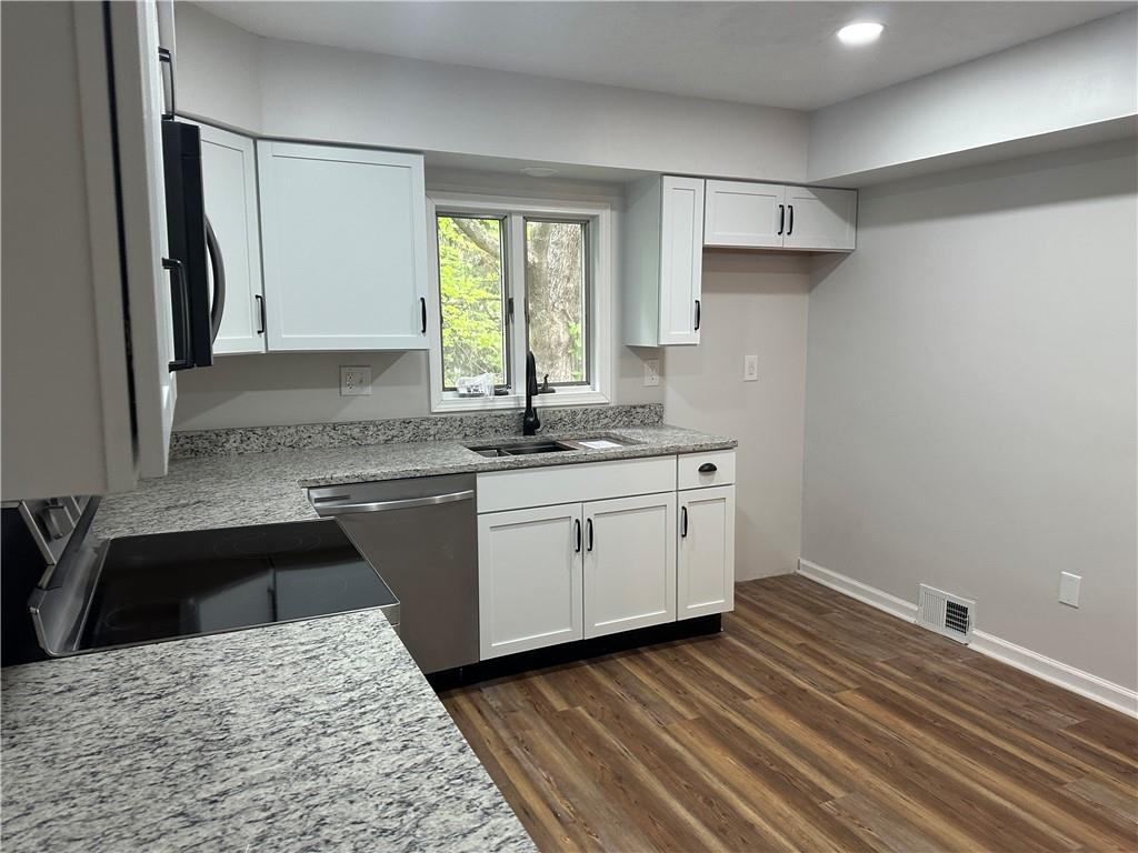 201 Clever Road McKees Rocks, PA 15136 - Photo 7 of 30 a kitchen with a sink stove and cabinets