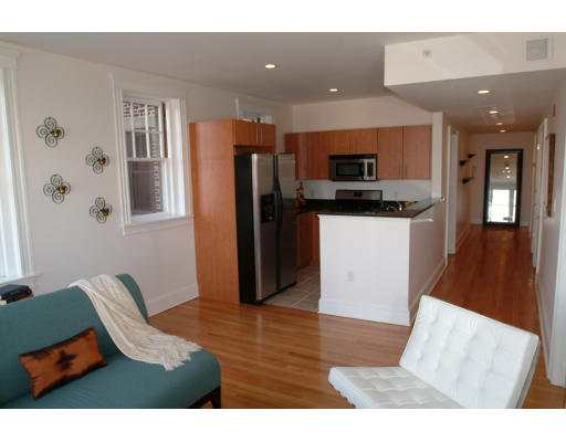 a kitchen with stainless steel appliances kitchen island granite countertop a refrigerator a stove top oven and a sink