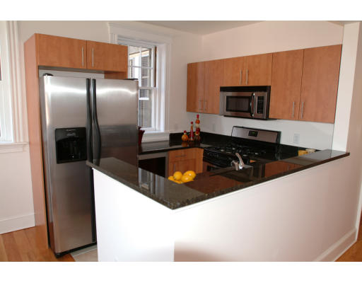 2025 Commonwealth Avenue, Unit 2 Boston, MA 02135 - Photo 3 of 11 a kitchen with stainless steel appliances a refrigerator a stove a microwave a sink and dishwasher