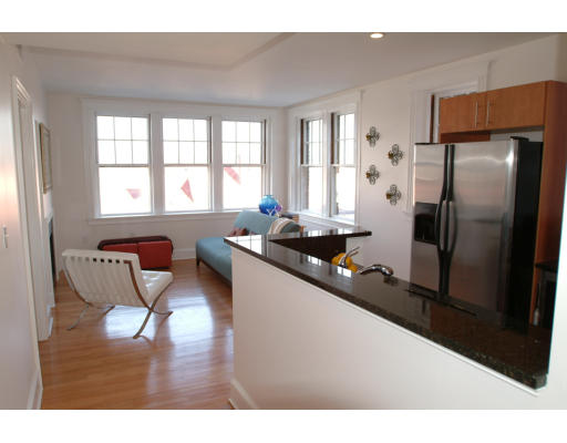 2025 Commonwealth Avenue, Unit 2 Boston, MA 02135 - Photo 5 of 11 a kitchen with stainless steel appliances kitchen island granite countertop a refrigerator and a sink