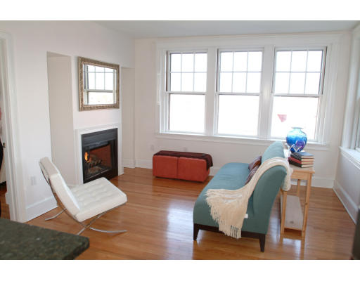 2025 Commonwealth Avenue, Unit 2 Boston, MA 02135 - Photo 6 of 11 a living room with furniture and a fireplace