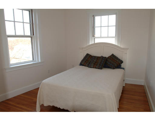 2025 Commonwealth Avenue, Unit 2 Boston, MA 02135 - Photo 8 of 11 a bedroom with a bed window and wall painting