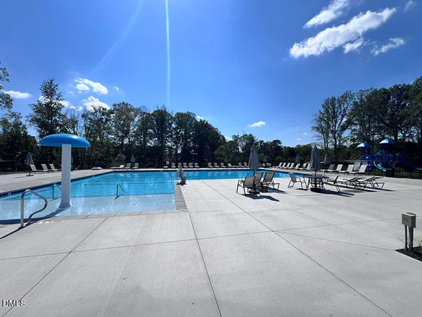 a view of swimming pool outdoor seating and living room