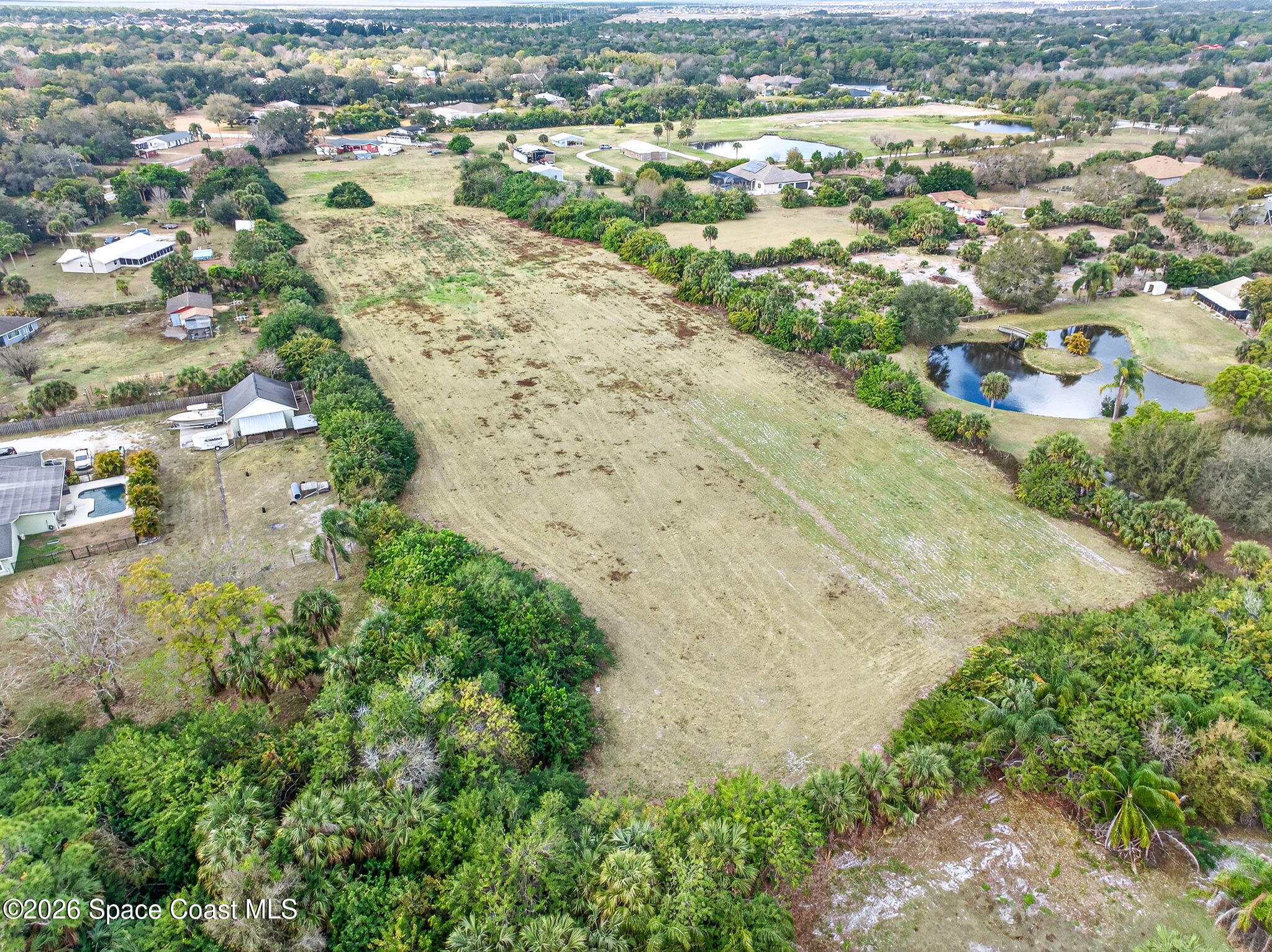 3825 Turtle Mound Road Melbourne, FL 32934 - Photo 3 of 19 an aerial view of lake and residential houses with outdoor space
