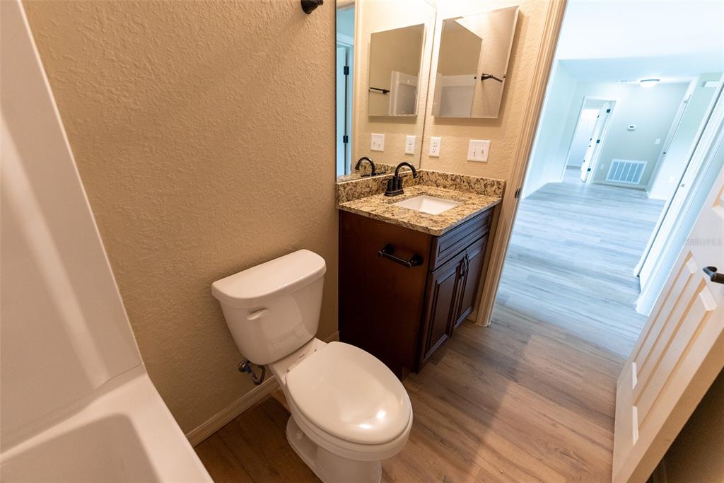 26 Malauka Radial Run Road Ocklawaha, FL 32179 - Photo 40 of 42 a bathroom with a toilet a sink and a mirror