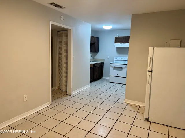 a kitchen with a refrigerator sink and cabinets