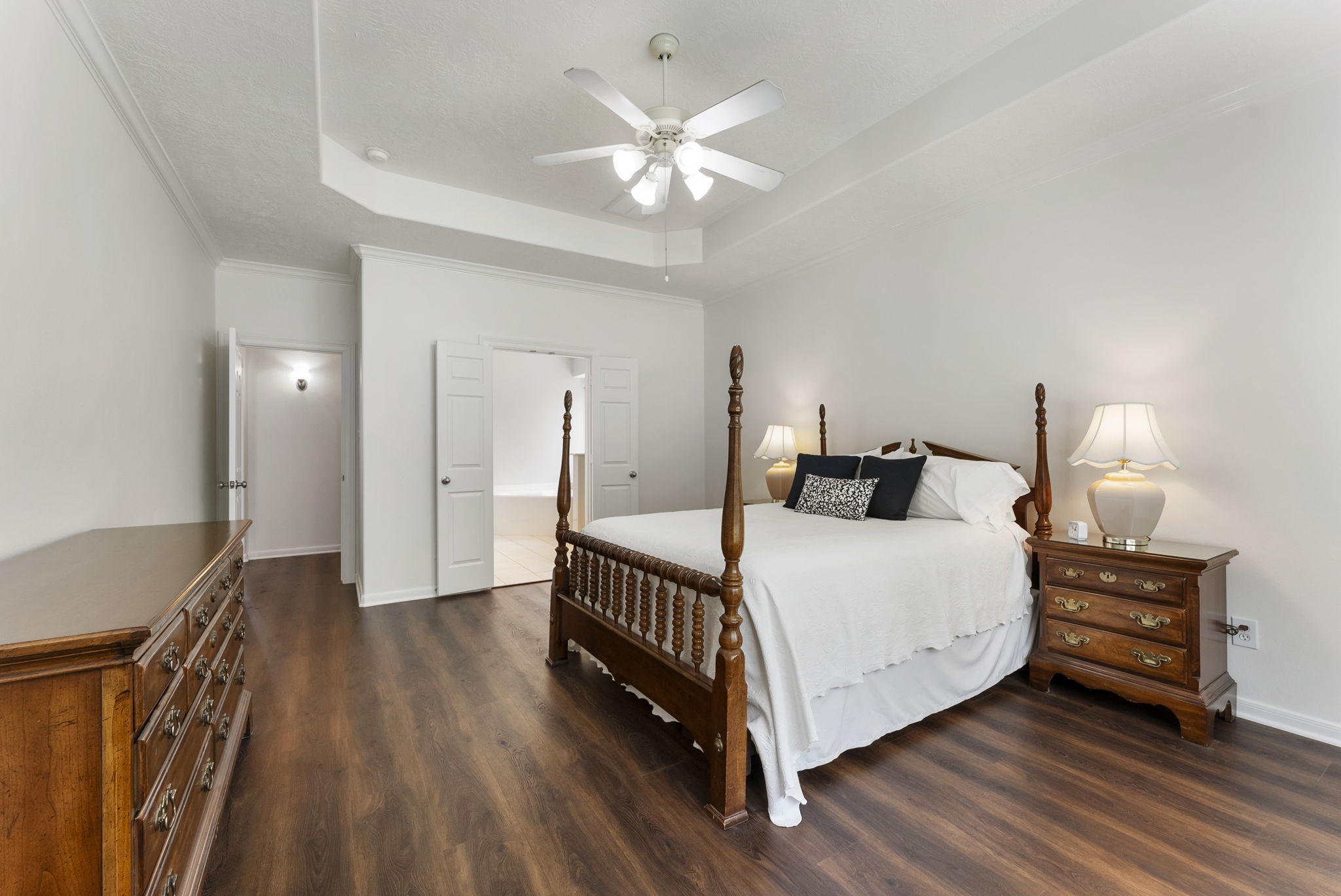6643 Knollbridge Lane Spring, TX 77379 - Photo 17 of 50 The primary suite is large enough for your oversized furniture and also features crown molding and hard surface flooring.