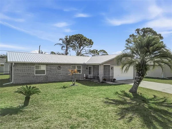 a backyard of a house with palm trees