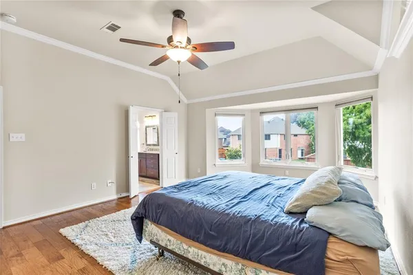 a bedroom with a large bed and a chandelier