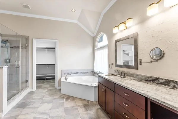 a bathroom with a granite countertop sink a mirror and a vanity