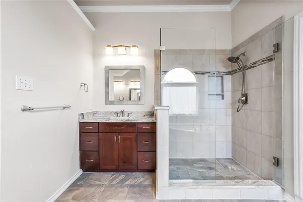 a bathroom with a granite countertop sink shower and a mirror