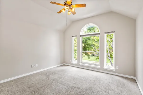 an empty room with windows and chandelier