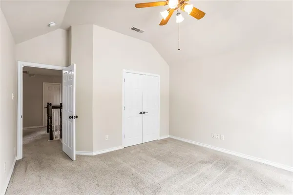 a view of a room with a ceiling fan
