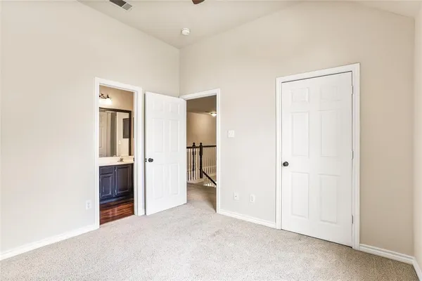 an empty room with closet and a bathroom