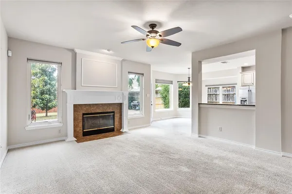 a view of a livingroom with a fireplace and window