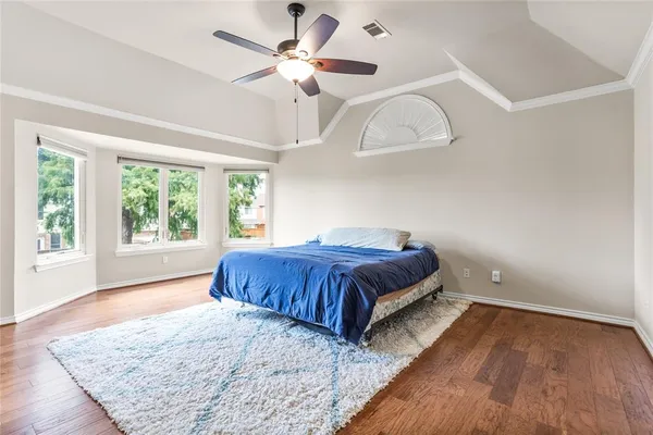 a spacious bedroom with a large bed and a large window
