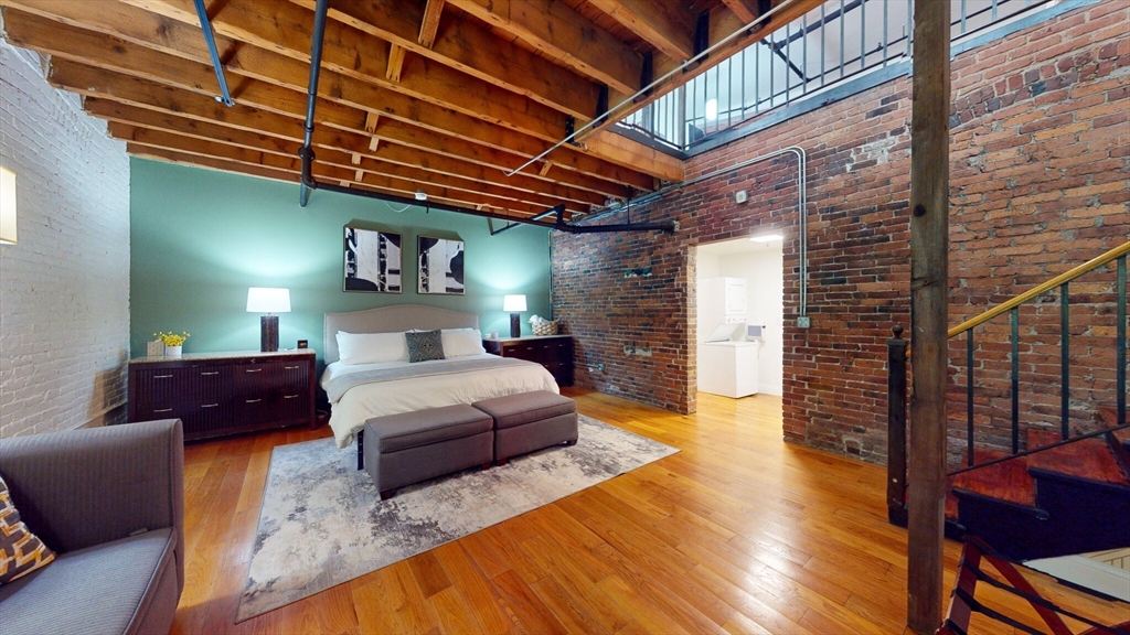 19 Stanhope Street, Unit 1B Boston, MA 02116 - Photo 1 of 20 a bedroom with a bed and wooden floor