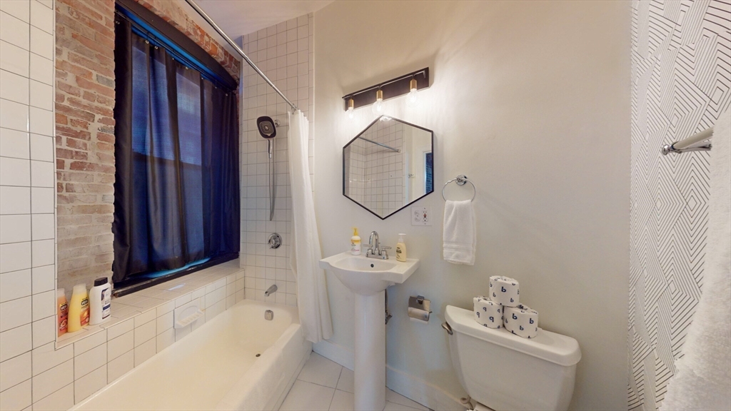 19 Stanhope Street, Unit 1B Boston, MA 02116 - Photo 11 of 20 a bathroom with a sink toilet and shower