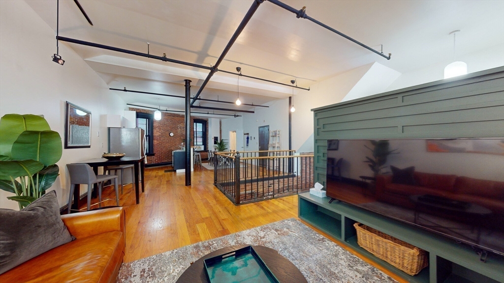 19 Stanhope Street, Unit 1B Boston, MA 02116 - Photo 12 of 20 a living room with lots of furniture and a potted plant