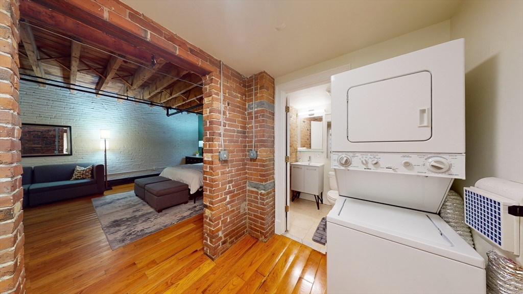 19 Stanhope Street, Unit 1B Boston, MA 02116 - Photo 20 of 20 a living room with furniture and a flat screen tv