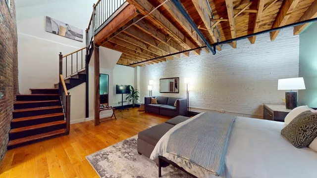 a bed room with a bed and a chair