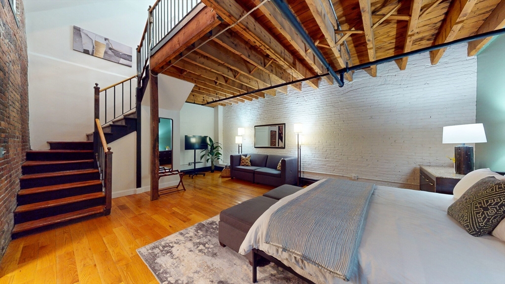 19 Stanhope Street, Unit 1B Boston, MA 02116 - Photo 2 of 20 a bed room with a bed and a chair