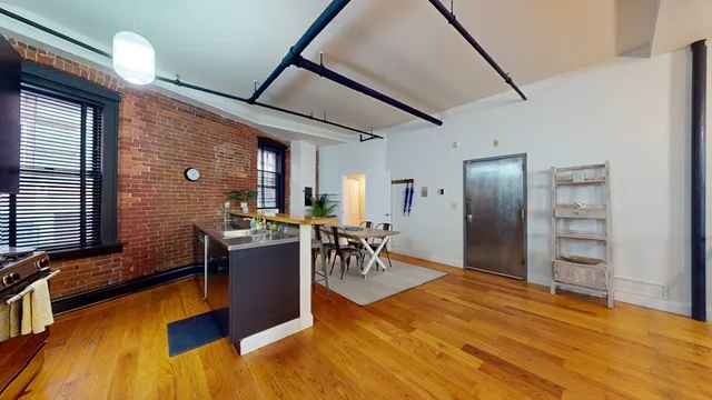a view of a livingroom with furniture and a window