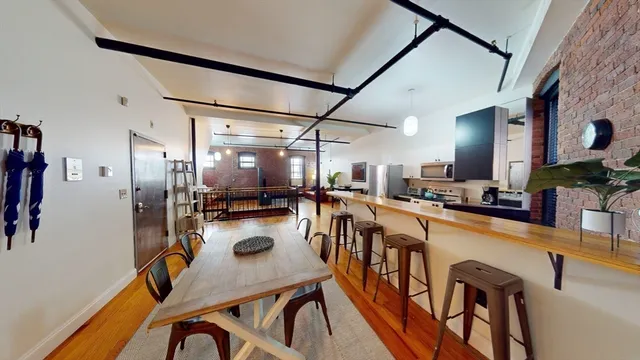 a kitchen with sink table and chairs