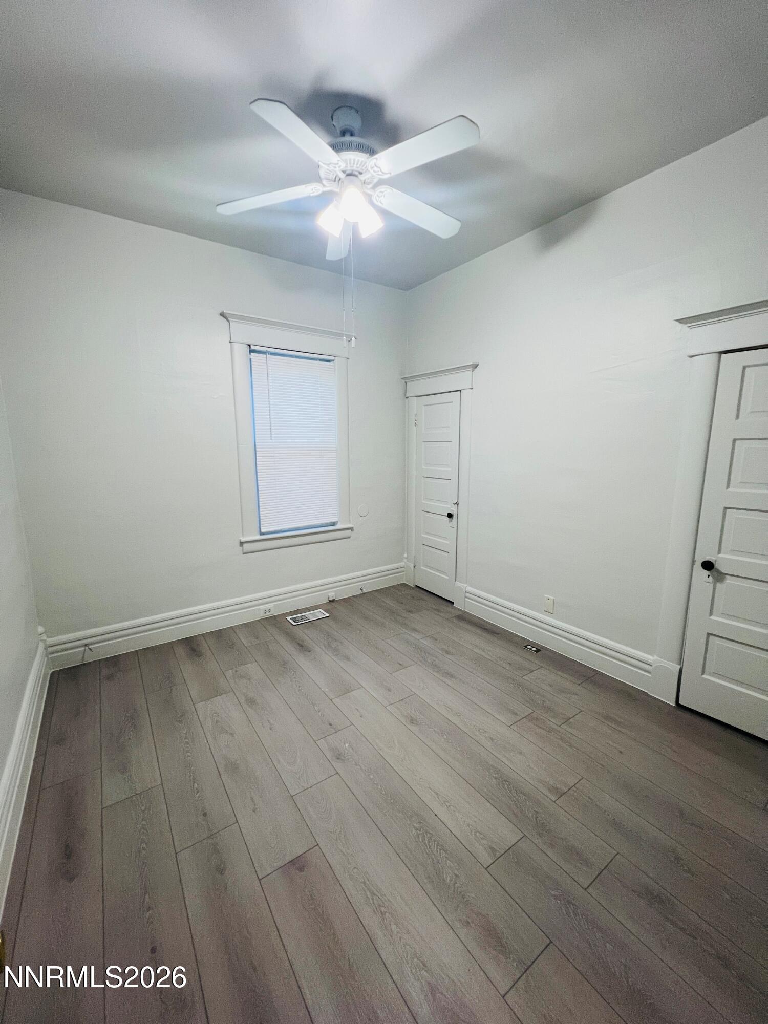 330 Stewart Street Reno, NV 89502 - Photo 4 of 21 an empty room with wooden floor and fan