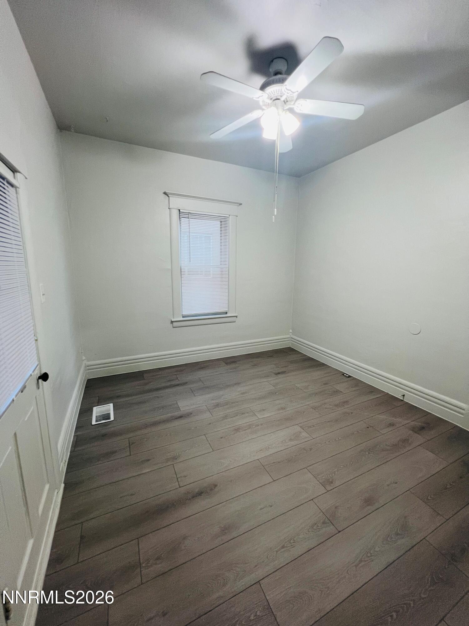 330 Stewart Street Reno, NV 89502 - Photo 5 of 21 wooden floor in an empty room with a mirror